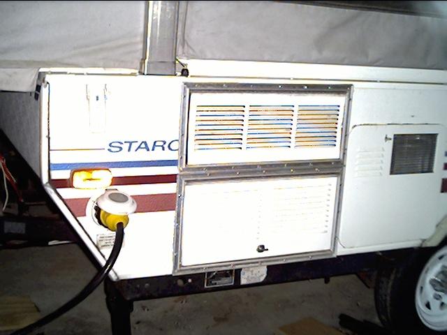 Refrigerator vents on left, water heater door at right.