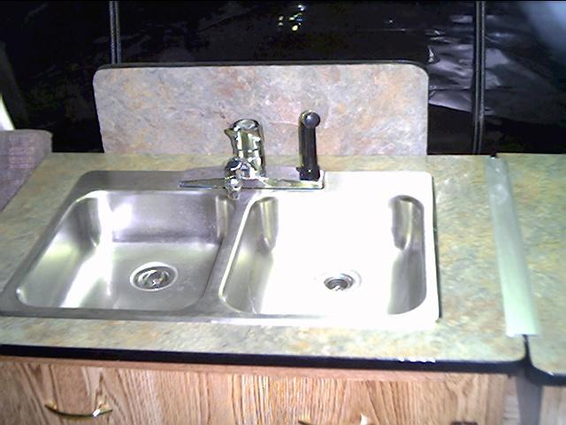 During transport the sink folds over the the back splash sits of the floor to keep the unit level.