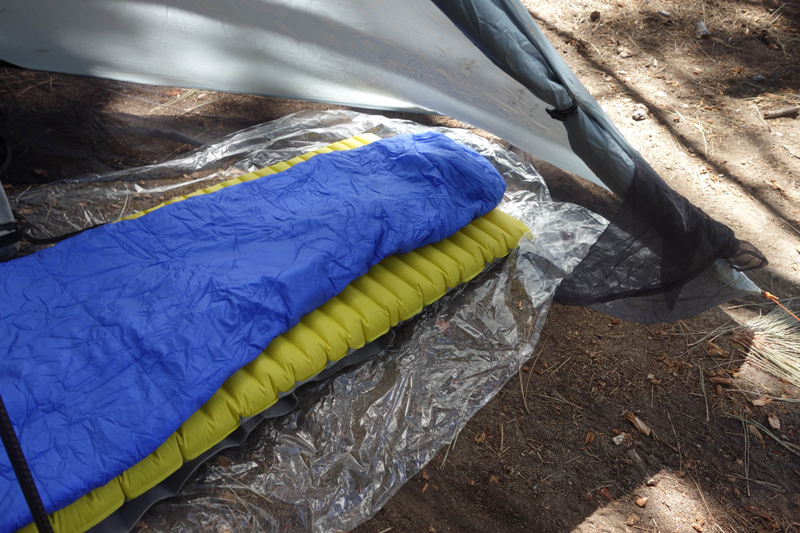 Gossamer Gear Polycro ground sheet is perfect for this shelter. Note the door tie at the right of the picture when you want the door open. I usually leave it open unless bugs are a problem. Properly oriented, the shelter will keep you dry with the door open.