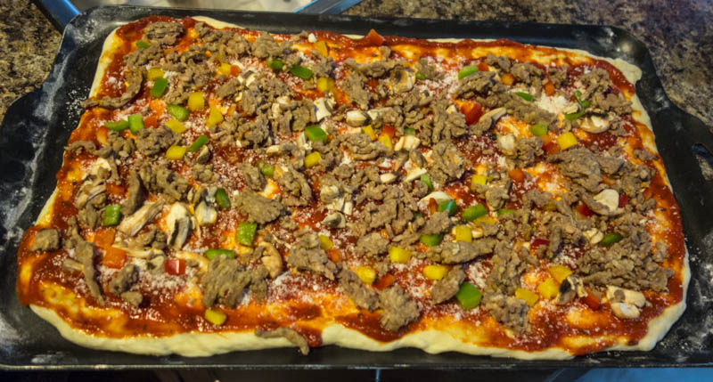 You remembered to cook and prepare some Italian Sausage a head of time. Now is the time to add it to the pizza.