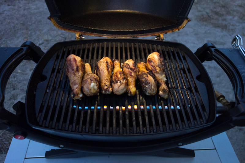 Grilling chicken at dusk