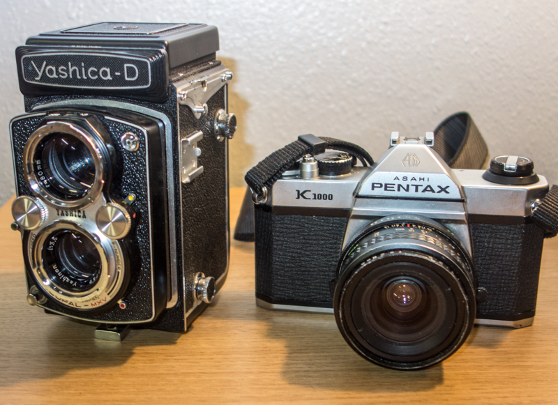 Left is a Yashica Twin Lens Reflex camera and right is a Pentax K100 35mm Single Lens Reflex. Both use film.