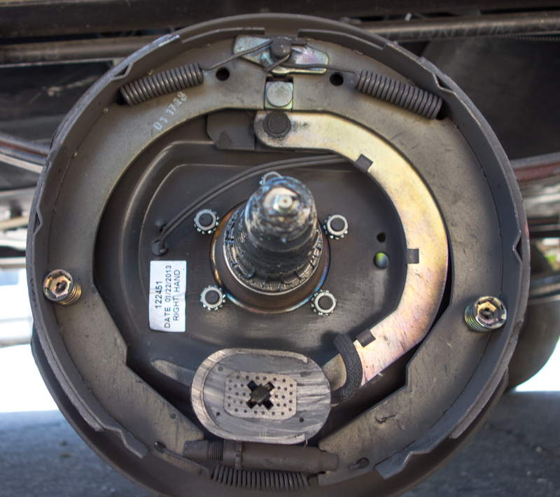 Part of the bearing service is to check the brakes -- note the grease fitting on the end of the spindle, which is not used for annual maintenance of the bearings